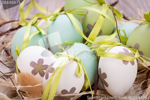 Image of Colourful green Easter eggs in straw