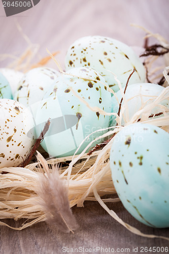 Image of Three natural blue Easter eggs in a basket