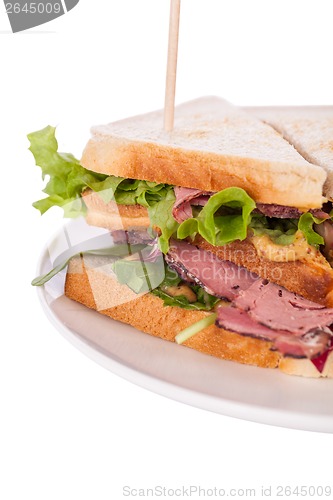 Image of Delicious pastrami club sandwich and pickles