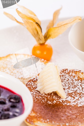 Image of tasty sweet pancakes with vanilla icecream and topping