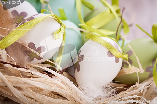 Image of Colourful green Easter eggs in straw