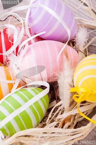 Image of colorful easter egg decoration on wooden background