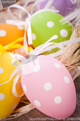 Image of colorful easter egg decoration on wooden background