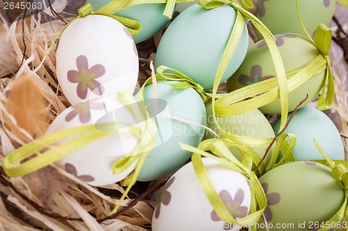 Image of Colourful green Easter eggs in straw