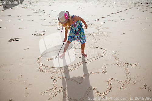 Image of Young girl playing on beach