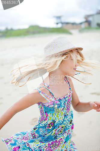 Image of Cute young girl having fun at beach