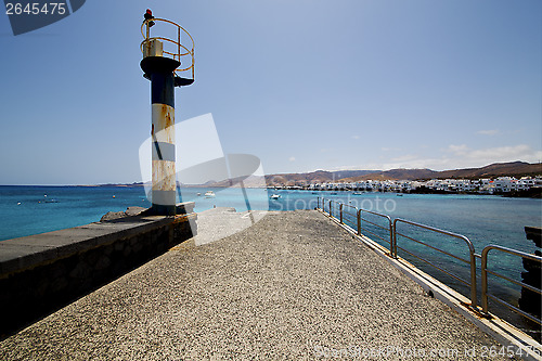 Image of lighthouse and pier boat in the blue sky   arrecife teguise