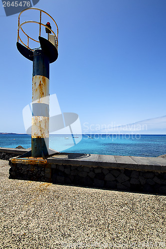 Image of lighthouse and pier boat in the lanzarote spain