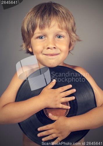 Image of boy with a record smiles
