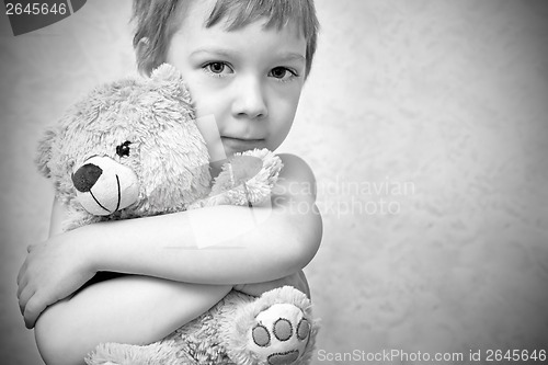 Image of Young boy with teddy bear, portrait