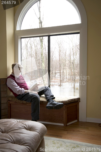 Image of reading book at suburban house