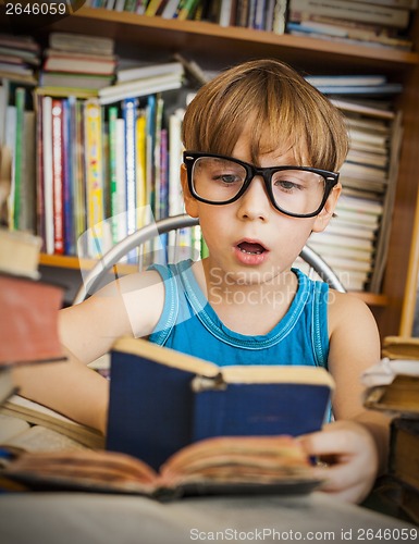 Image of boy reading book while preparing for lesson