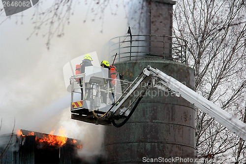 Image of Firefighters Extinguishing Fire on Hydraulic Crane Platform