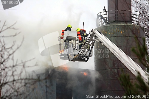 Image of Firefighters Extinguishing Fire on Hydraulic Crane Platform