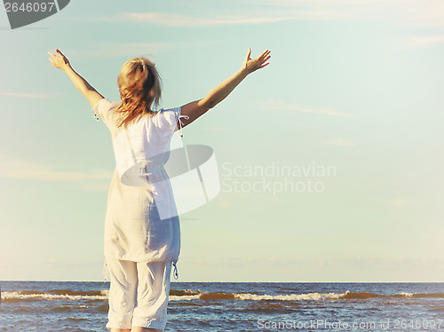 Image of young woman and sea