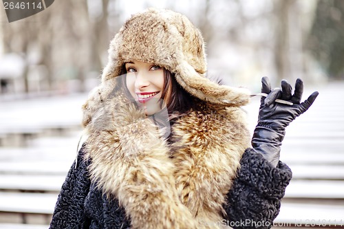 Image of Joyfull russian woman in fur hat and coat