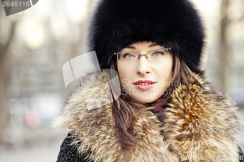 Image of Woman wearing fur hat and glasses