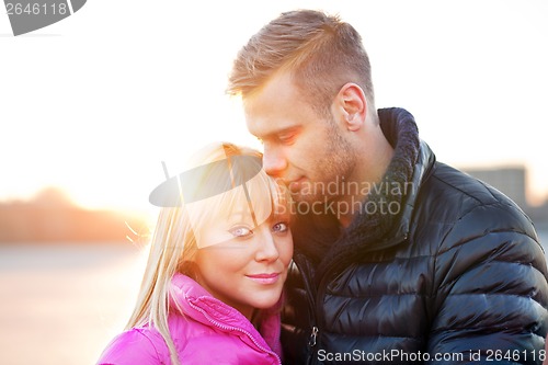 Image of Young man embraces his girlfriend