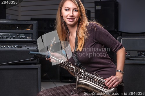 Image of Pretty woman with saxophone