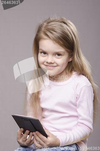 Image of Portrait girl with a small mirror in hands of