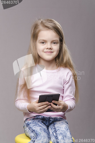 Image of Portrait girl with a small mirror in hands of