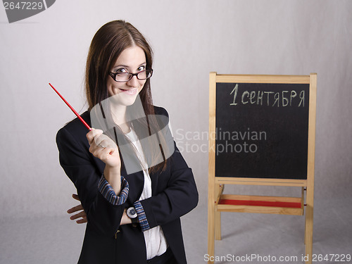 Image of Portrait of teacher, with pointer and a Board