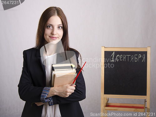 Image of Portrait of the teacher with textbooks and Board