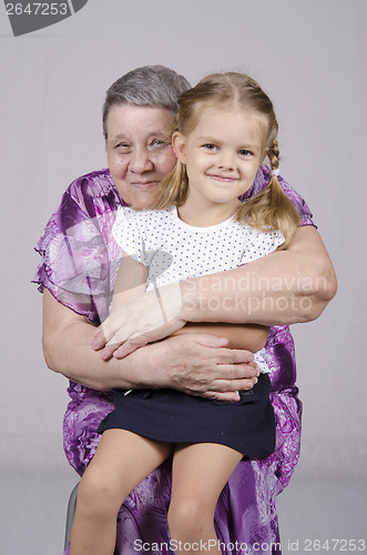 Image of Portrait of an elderly woman covering her granddaughter