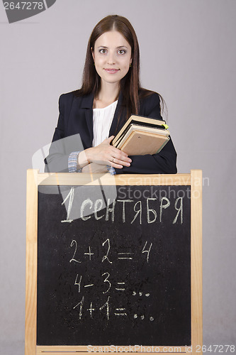 Image of Portrait of the teacher with textbooks and Board