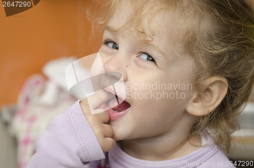 Image of little girl with enthusiasm and eats roll pleasure