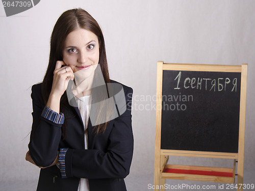 Image of Portrait of teacher in a great mood and Board