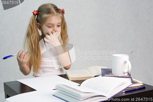 Image of Girl leafing through book and wrote on a sheet of paper abstract sitting