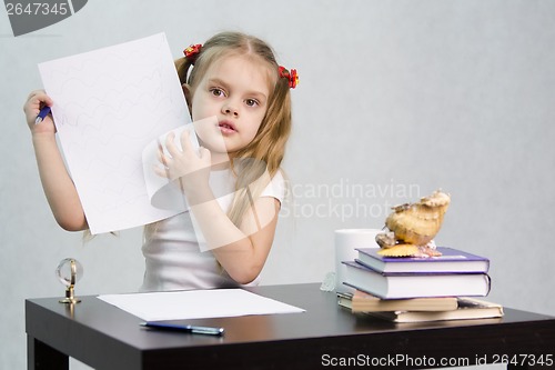 Image of Girl shows sheet of paper with scribbled notes