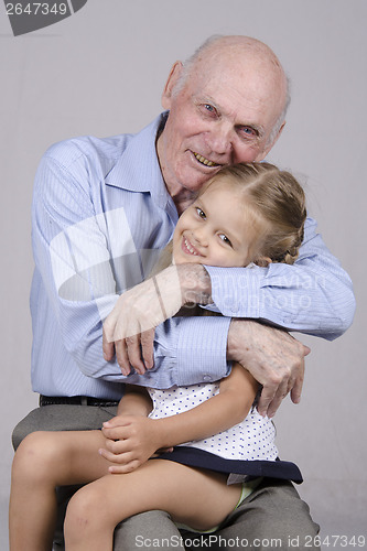 Image of Portrait of an elderly man embracing a granddaughter