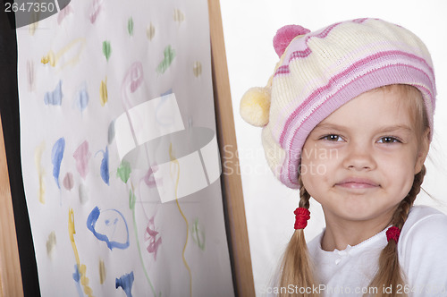 Image of Portrait girl in image of artist, near drawn her picture