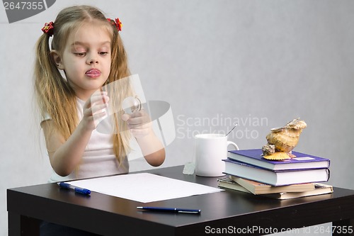 Image of girl thoughtfully and effortlessly turns glass globe