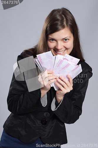 Image of Young long-haired woman holding money