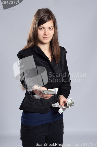 Image of Young long-haired woman holding money