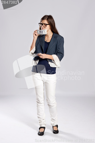 Image of Young long-haired woman and money