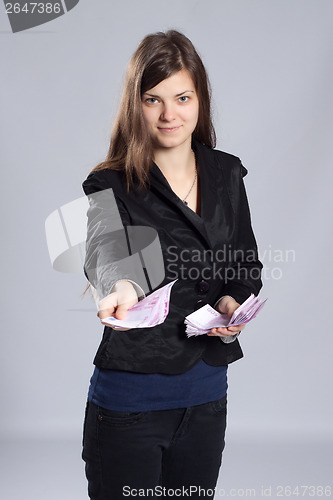 Image of Young long-haired woman holding money