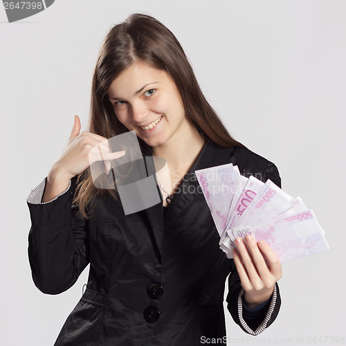 Image of Young long-haired woman holding money