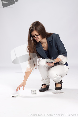 Image of Young long-haired woman and money