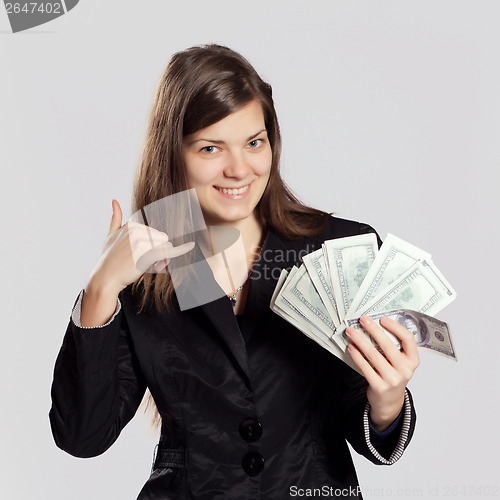 Image of Young long-haired woman holding money