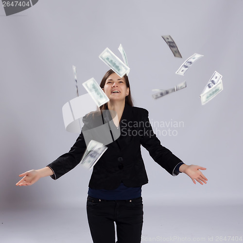 Image of Young long-haired woman throw money