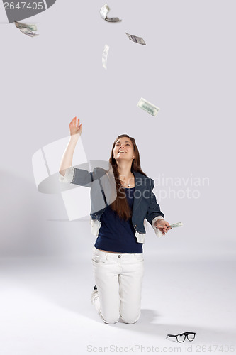 Image of Young long-haired woman throw money