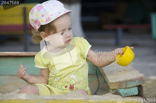 Image of  Little girl playing in the sandbox