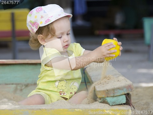 Image of  Little girl playing in the sandbox