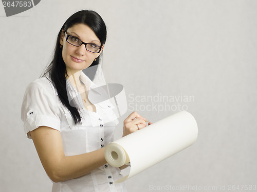 Image of girl wrote in pencil on the roll of paper
