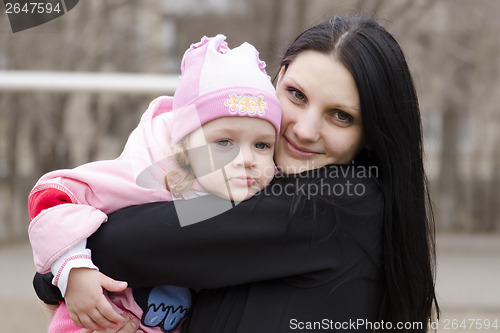 Image of little girl thoughtfully lies on shoulder of my mother