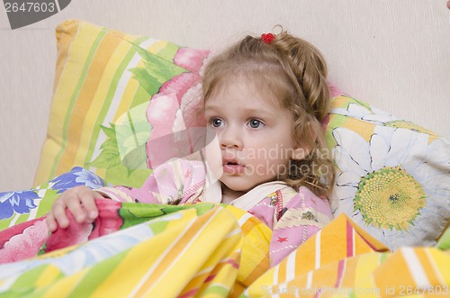 Image of Two-year-old girl is in bed under the blanket